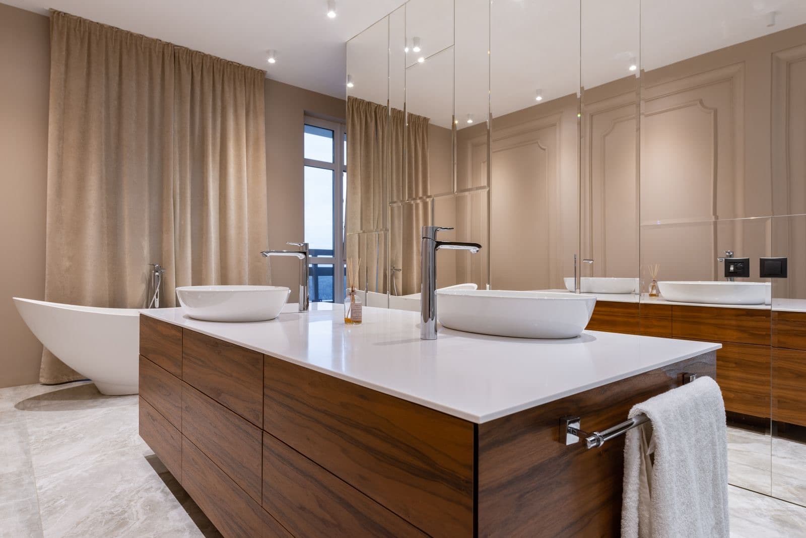 stock photograph of a bathroom vanity unit, twin basins and a freestanding bath. Licensed stock picture, not a photograph of Fylde Bathrooms, its staff, its premises or a job it carried out.