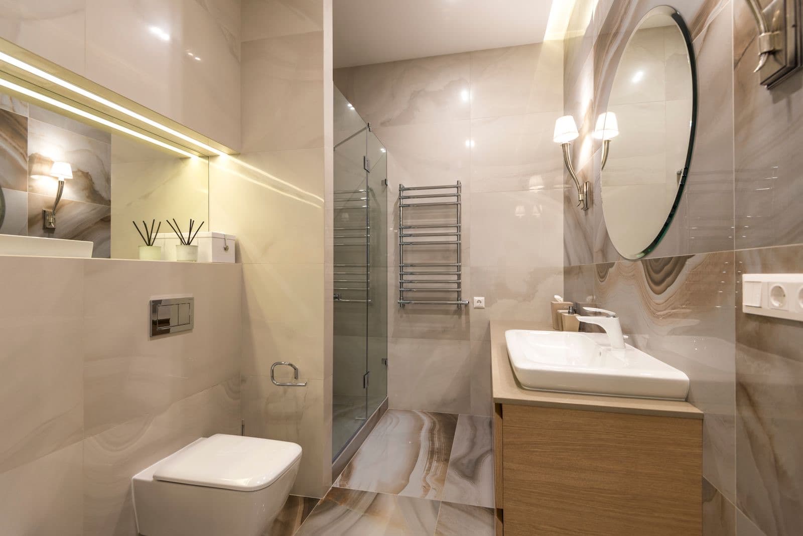 stock photograph of a compact tiled bathroom with a glass shower enclosure and fitted basin. Licensed stock picture, not a photograph of Fylde Bathrooms & GM Plumbing, its staff, its premises or a job it carried out.